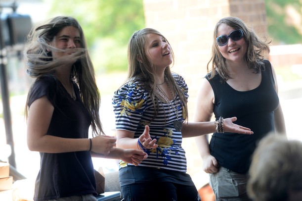 Friends, from left, Kylee (no last name given), 16, of Bloomfield, Hailey Broderick, 14, of Holly and Bia Cassano, 15, Pontiac dance as Alejandra O'Leary and her band performs at the Summer Concert Series on the porch at AnnArbor.com. Melanie Maxwell I AnnArbor.com